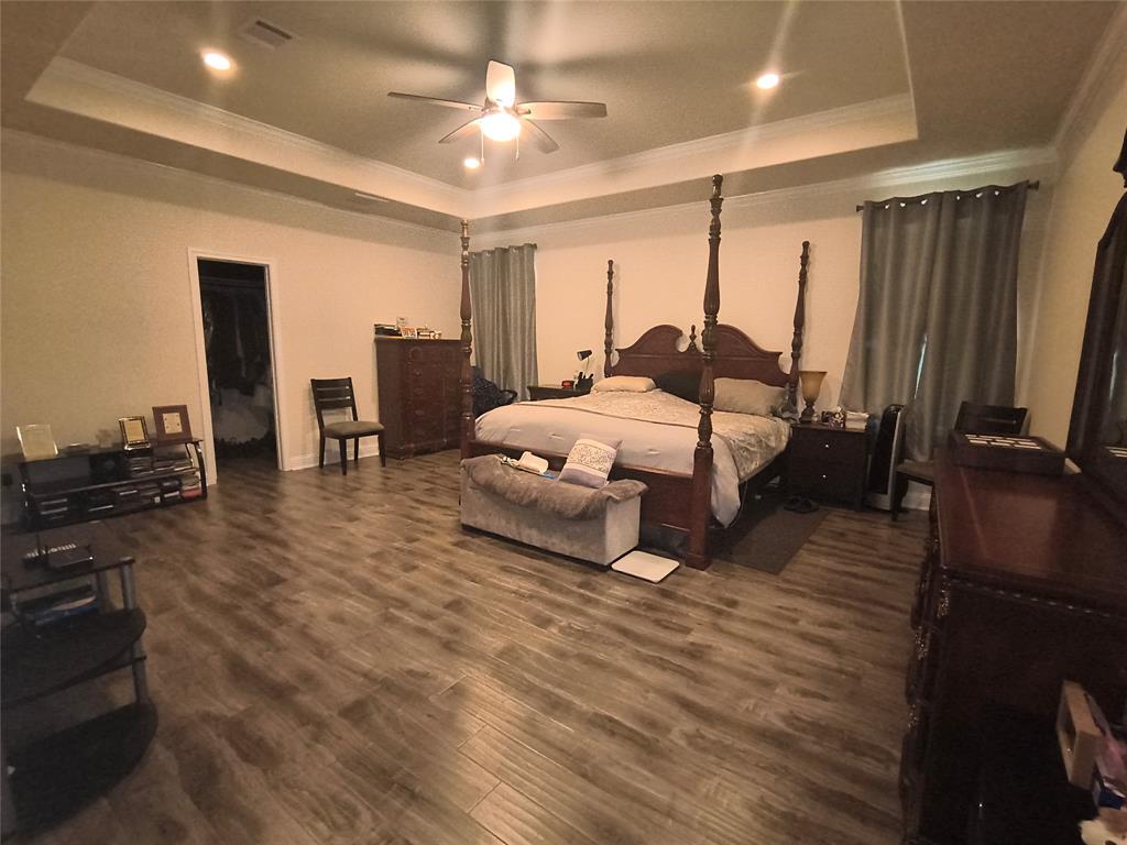 3027 Ames Road Lancaster, TX 75134 - Photo 16 of 35 Spacious bedroom featuring wood-finish flooring and a tray ceiling with recessed lighting