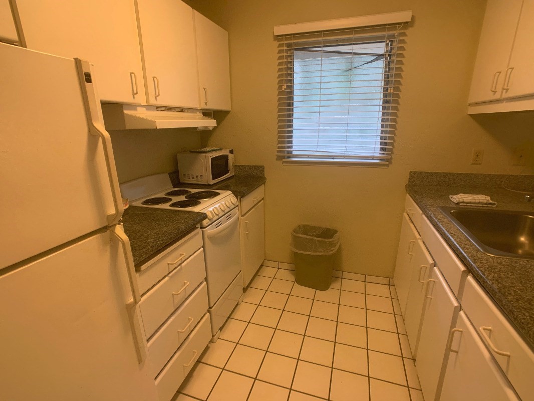525 Aleka Loop, Unit D5 Kapaa, HI 96746 - Photo 8 of 11 a kitchen with a sink and a stove top oven