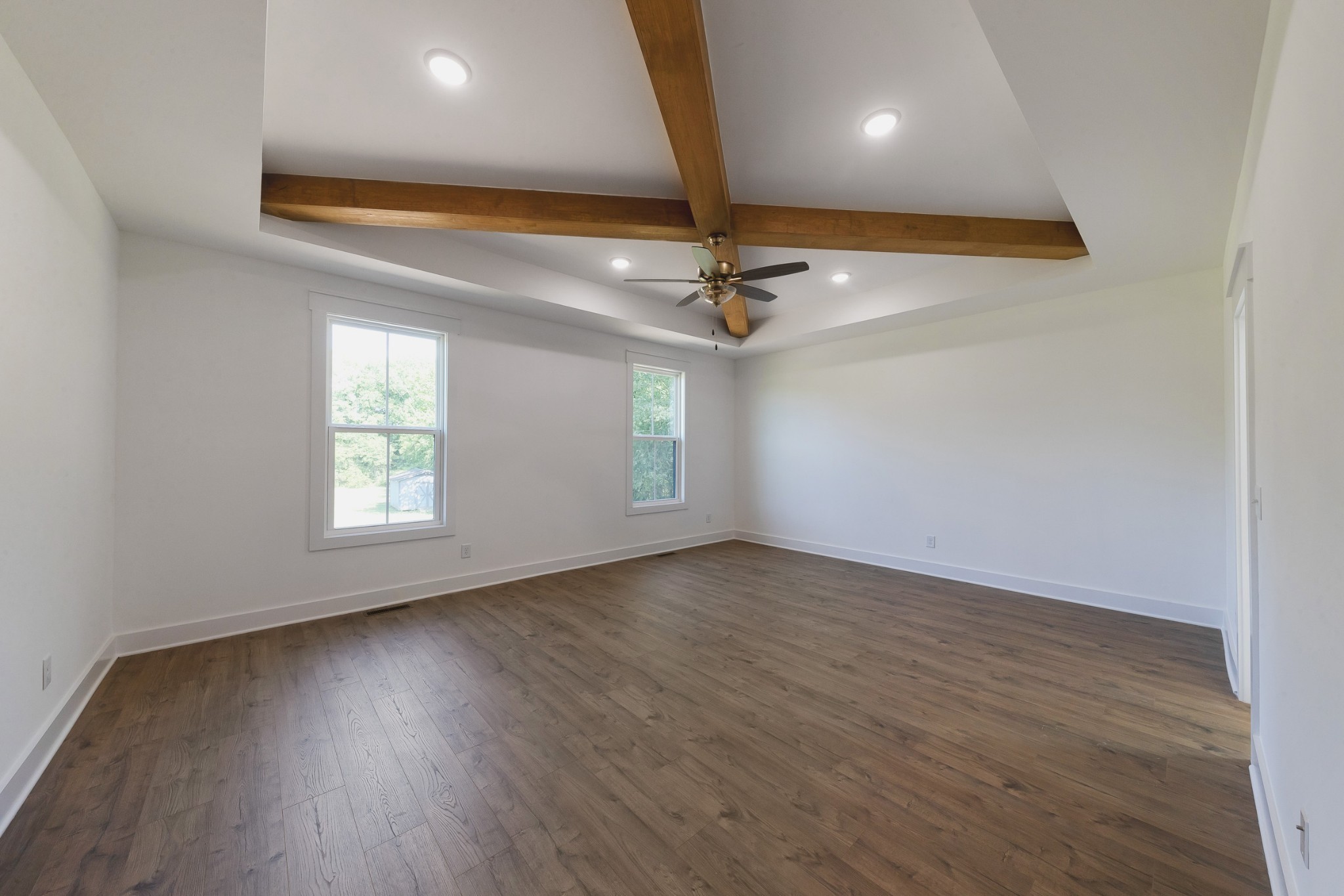 6616 Old Zion Road Columbia, TN 38401 - Photo 23 of 52 an empty room with wooden floor chandelier fan and windows