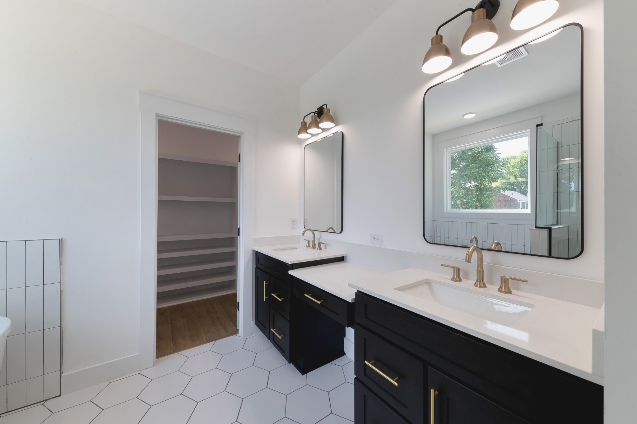 6616 Old Zion Road Columbia, TN 38401 - Photo 26 of 52 a bathroom with a double vanity sink a mirror and a bathtub