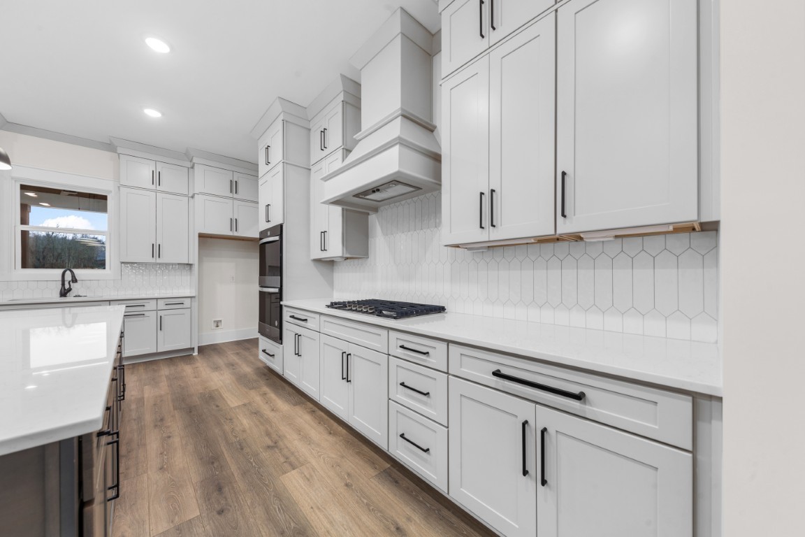 6616 Old Zion Road Columbia, TN 38401 - Photo 5 of 29 a kitchen with stainless steel appliances granite countertop a stove a sink and white cabinets