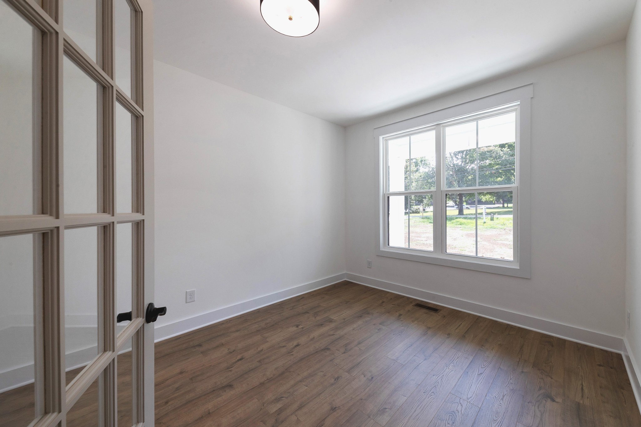 6616 Old Zion Road Columbia, TN 38401 - Photo 7 of 52 an empty room with wooden floor and window