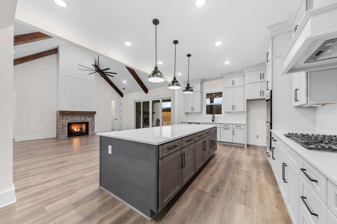 6616 Old Zion Road Columbia, TN 38401 - Photo 7 of 29 a large kitchen with stainless steel appliances kitchen island granite countertop a stove and a wooden floors