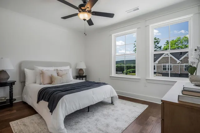 a bedroom with a large bed and a window