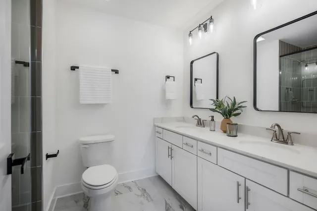 a bathroom with a toilet sink and mirror