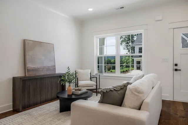 a living room with furniture potted plant and a window