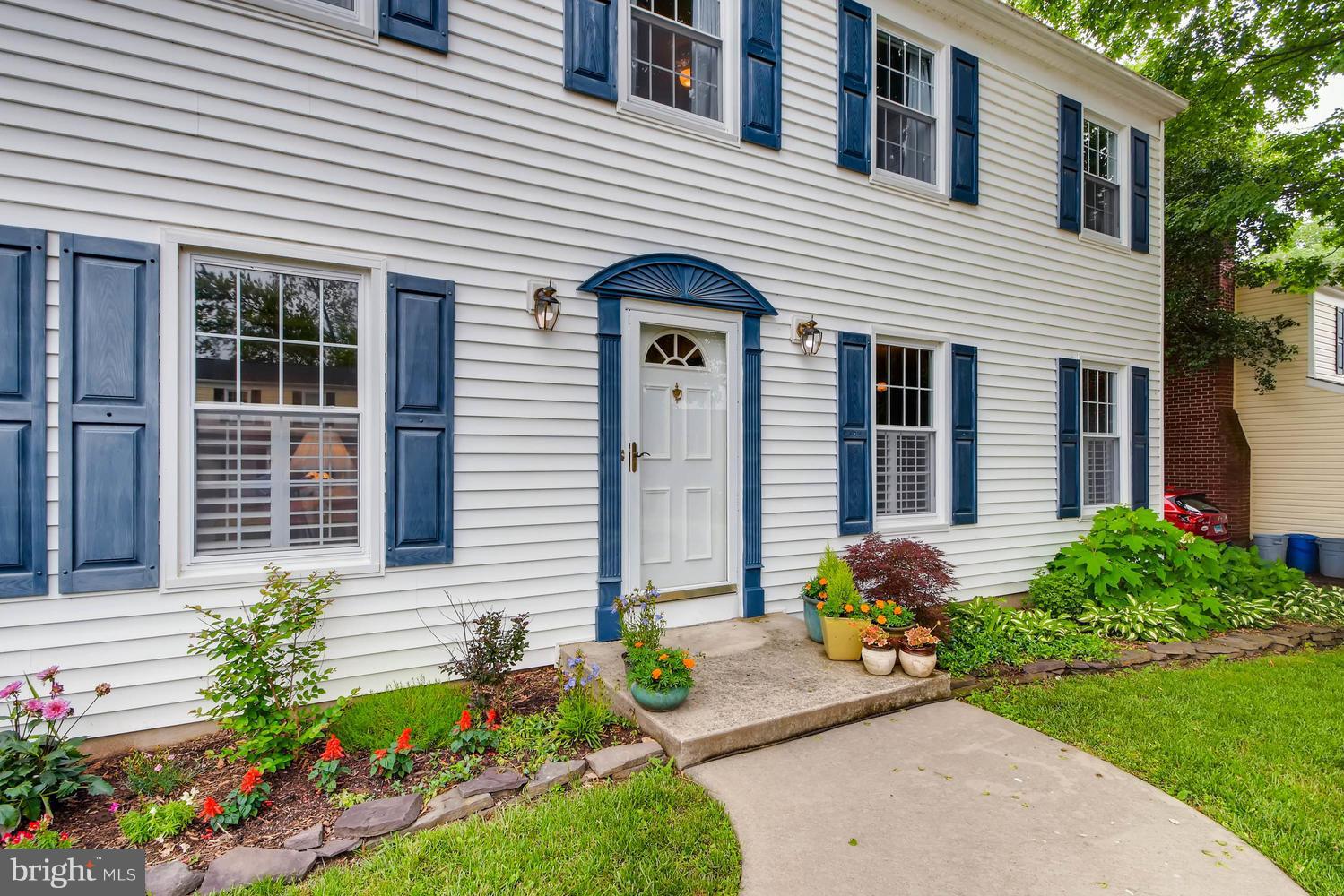 a front view of a house with a yard and a garden