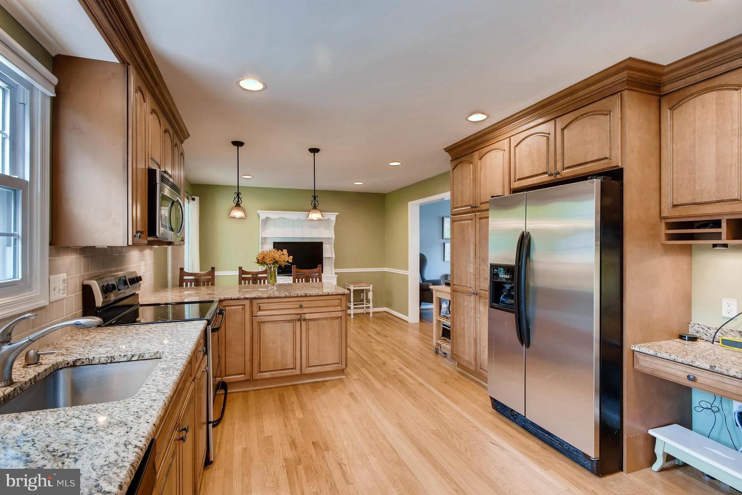 10510 Longbranch Road Cockeysville, MD 21030 - Photo 6 of 28 a kitchen with stainless steel appliances granite countertop a refrigerator a sink dishwasher a oven with white cabinets and wooden floor
