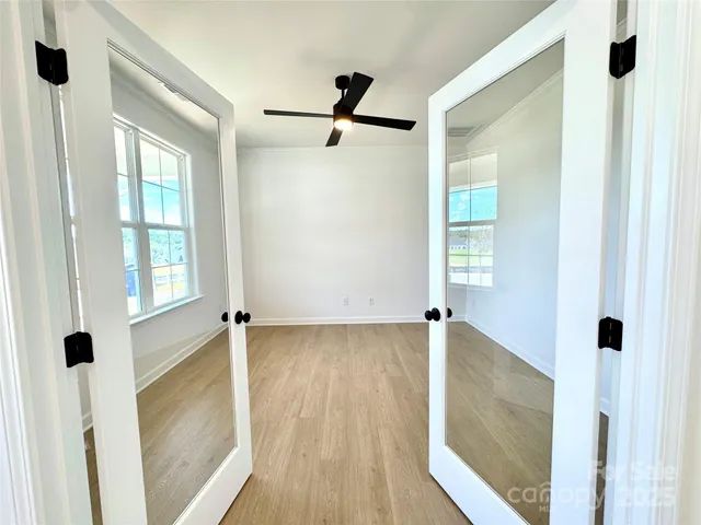 a view of a walk in closet and wooden floor