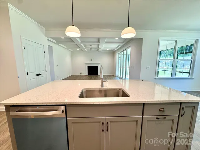 a kitchen with a table and a chandelier