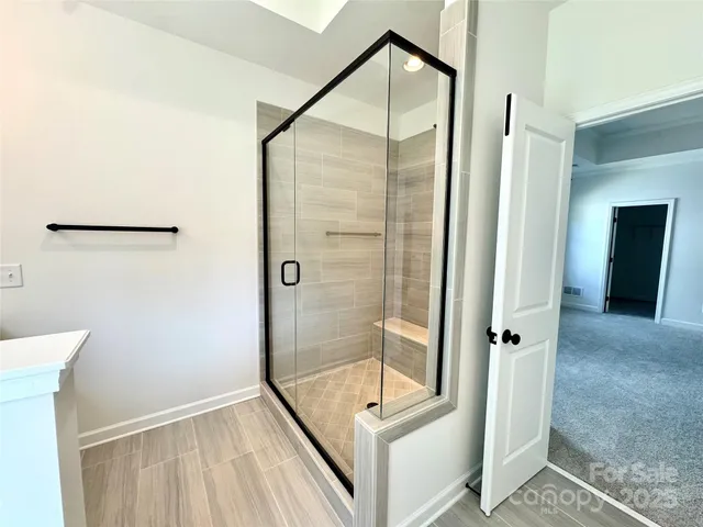 a bathroom with a glass shower door