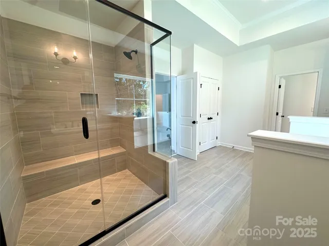 a bathroom with a shower and a sink