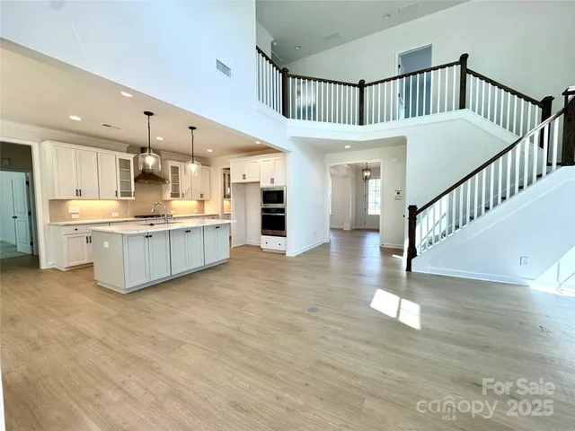 a view of kitchen with cabinets and wooden floor