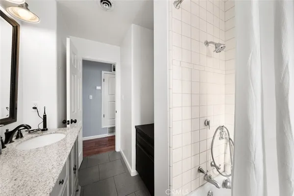 a bathroom with a granite countertop sink a toilet and a mirror