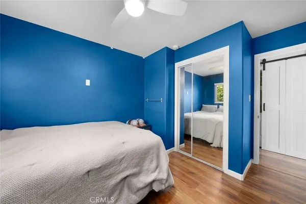 a bedroom with a bed and a mirror