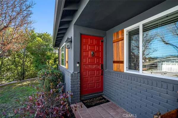 a view of front door of house with yard