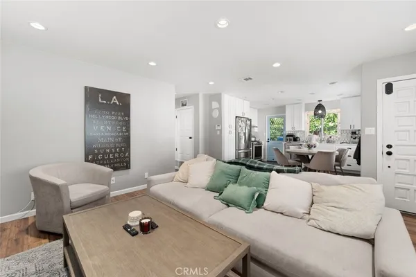 a living room with furniture and wooden floor
