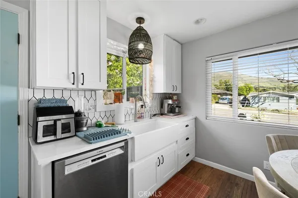 a kitchen with a stove a sink and a window