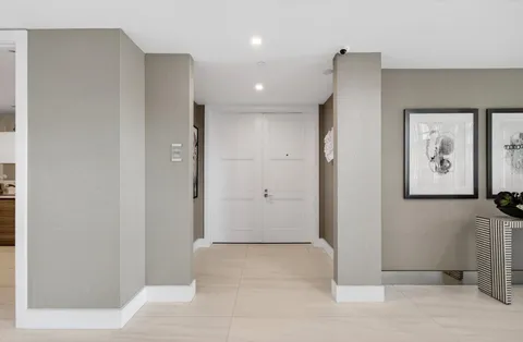 a bathroom with a painting on the wall and shower