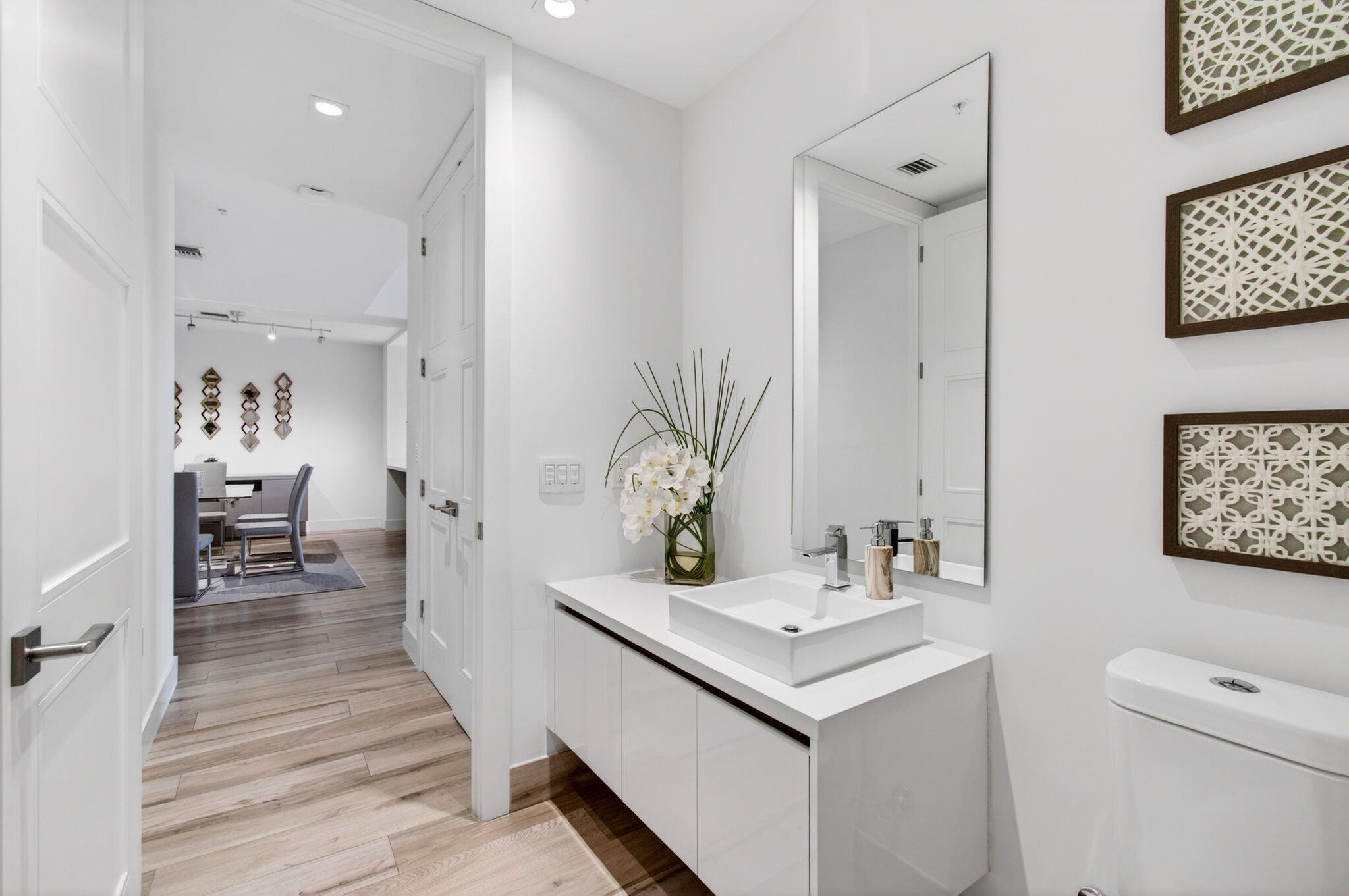 155 East Boca Raton Road, Unit TH3 Boca Raton, FL 33432 - Photo 23 of 139 a bathroom with a sink a toilet and a mirror