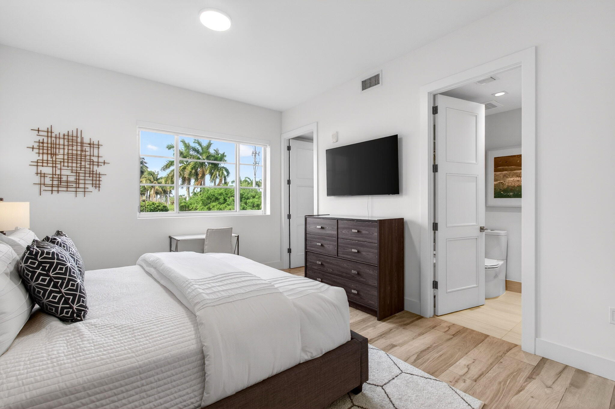 155 East Boca Raton Road, Unit TH3 Boca Raton, FL 33432 - Photo 73 of 139 a bedroom with a bed and a flat screen tv