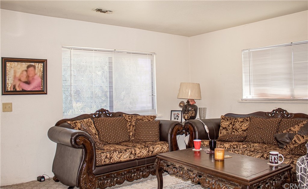 5716 Tyler Street Riverside, CA 92503 - Photo 1 of 1 a living room with furniture and wooden floor