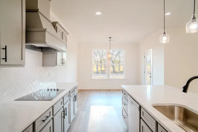 a kitchen with a sink stove and cabinets