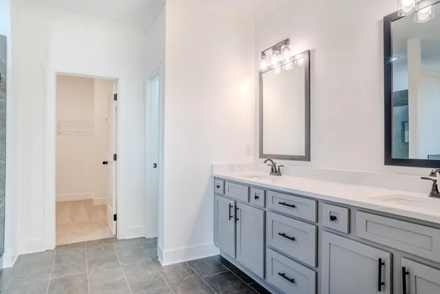 a bathroom with a double vanity sink and mirror