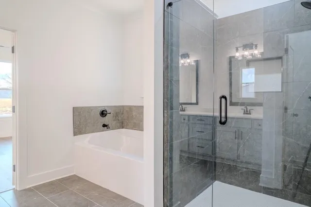 a bathroom with a bathtub and shower