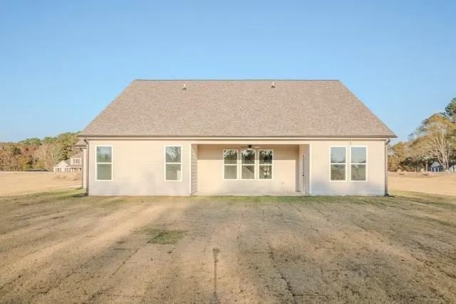 a view of a house with a backyard