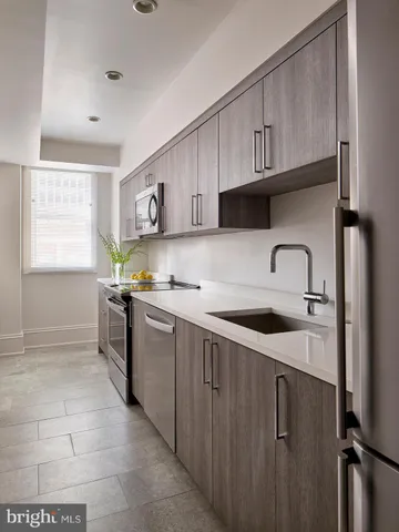 a kitchen with a sink cabinets and window