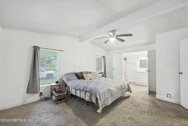 a bedroom with a bed and a ceiling fan