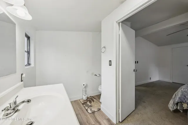 a en suite bathroom with a tub shower and a sink
