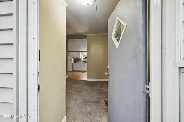 a view of livingroom and hallway with wooden floor