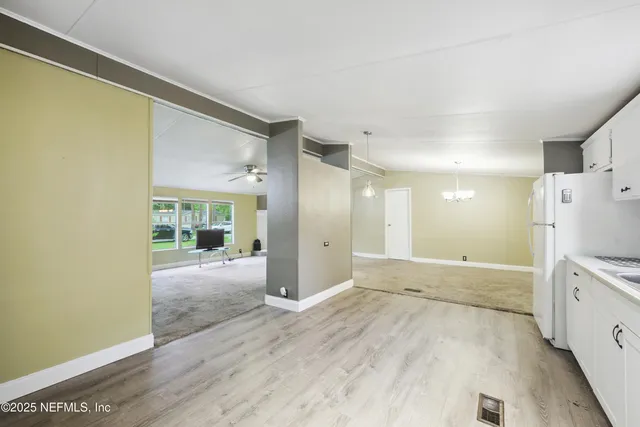 a view of a kitchen with a sink and a refrigerator