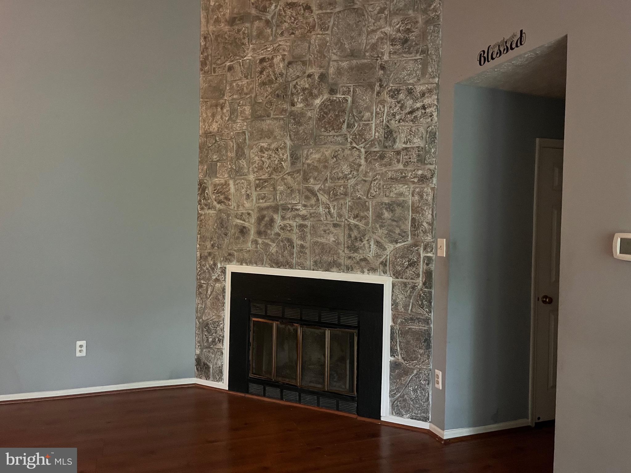 903 K Woodbridge Court, Unit 903K Edgewood, MD 21040 - Photo 1 of 9 a view of empty room with wooden floor and a fireplace