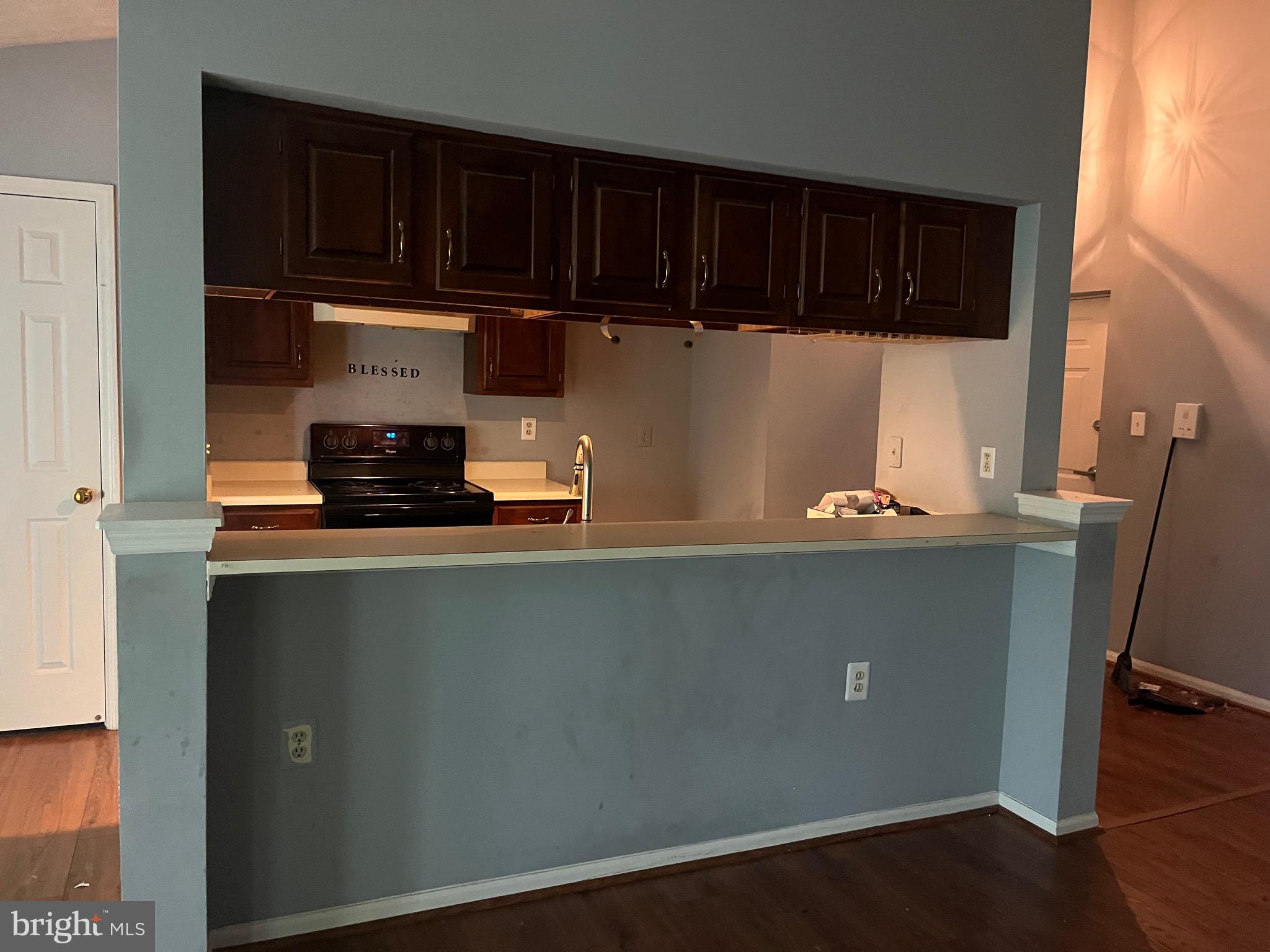 903 K Woodbridge Court, Unit 903K Edgewood, MD 21040 - Photo 9 of 9 a kitchen with wooden cabinets and a stove top oven