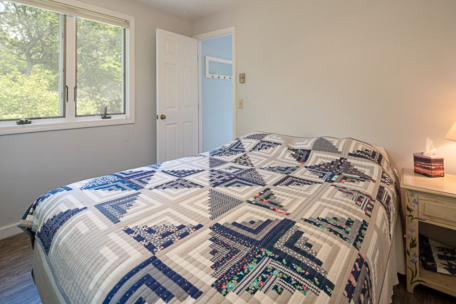 33 Codman Spring Road Edgartown, MA 02539 - Photo 15 of 24 a bed sitting in a bedroom next to a window