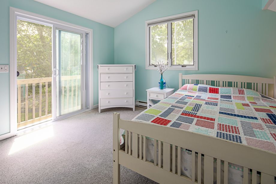 33 Codman Spring Road Edgartown, MA 02539 - Photo 17 of 24 a bedroom with a bed and a baby crib next to a window