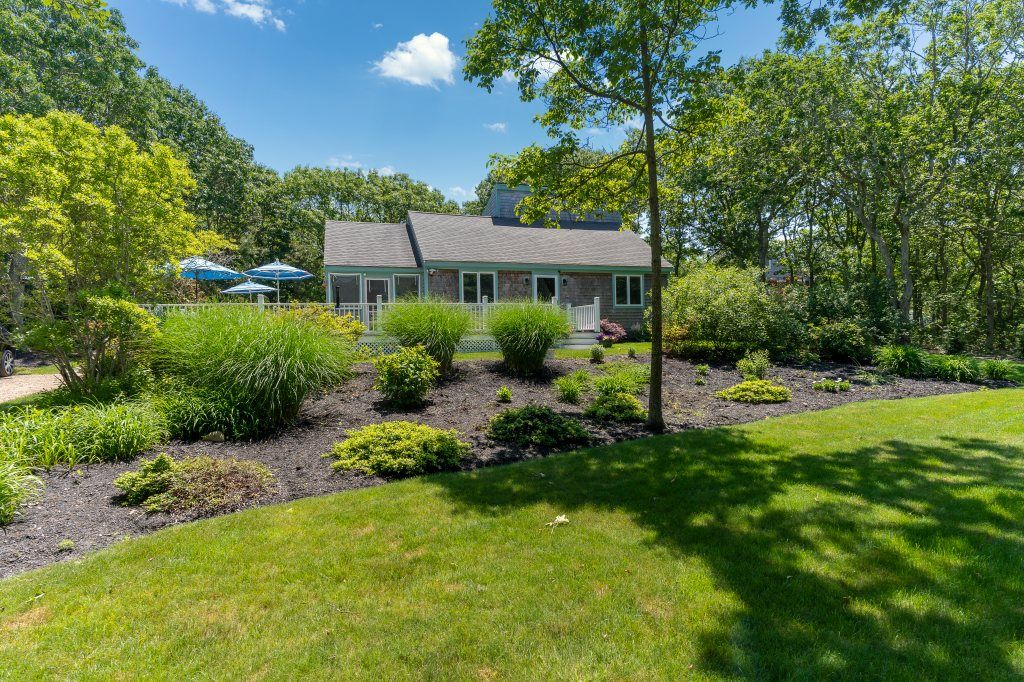 33 Codman Spring Road Edgartown, MA 02539 - Photo 2 of 24 a view of a house with a yard and potted plants