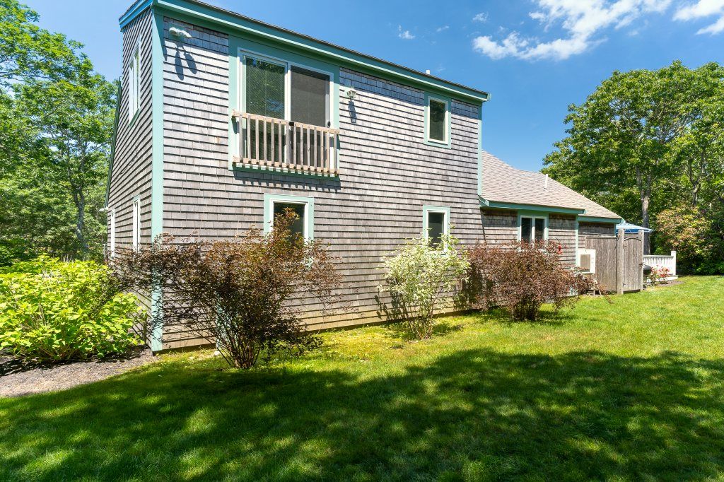 33 Codman Spring Road Edgartown, MA 02539 - Photo 22 of 24 a view of backyard with a garden and plants