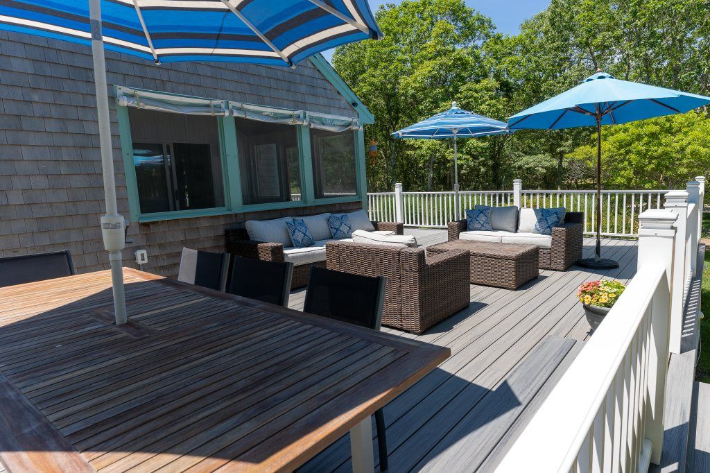 33 Codman Spring Road Edgartown, MA 02539 - Photo 5 of 24 a view of a wooden deck with furniture