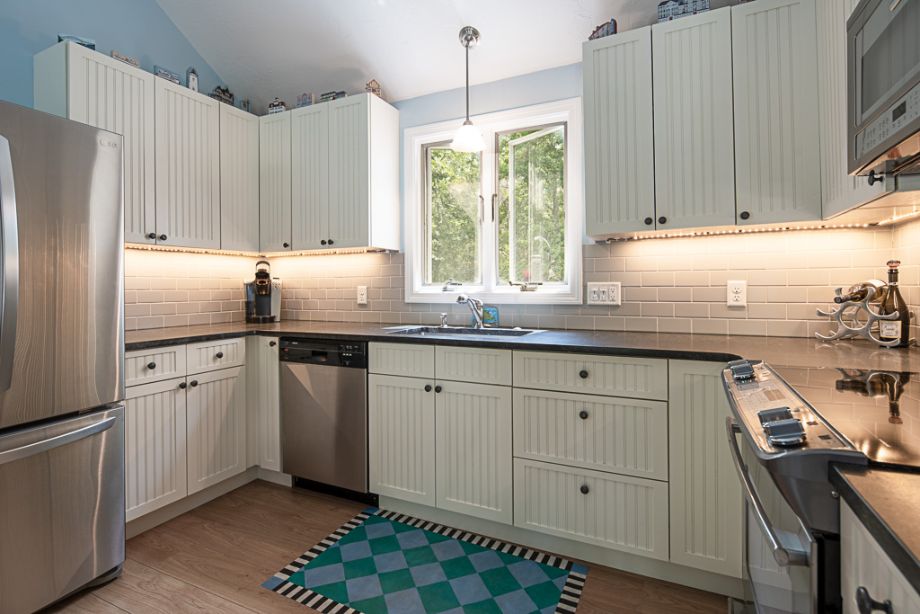 33 Codman Spring Road Edgartown, MA 02539 - Photo 9 of 24 a kitchen with stainless steel appliances granite countertop a sink a stove and a refrigerator