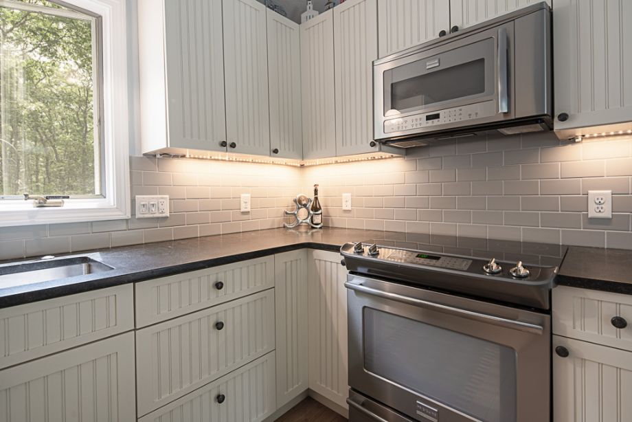 33 Codman Spring Road Edgartown, MA 02539 - Photo 10 of 24 a kitchen with granite countertop white cabinets appliances and a sink
