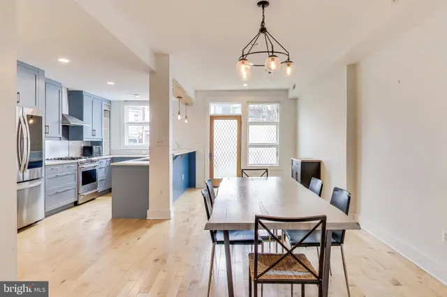 a view of a dining room with furniture and a chandelier