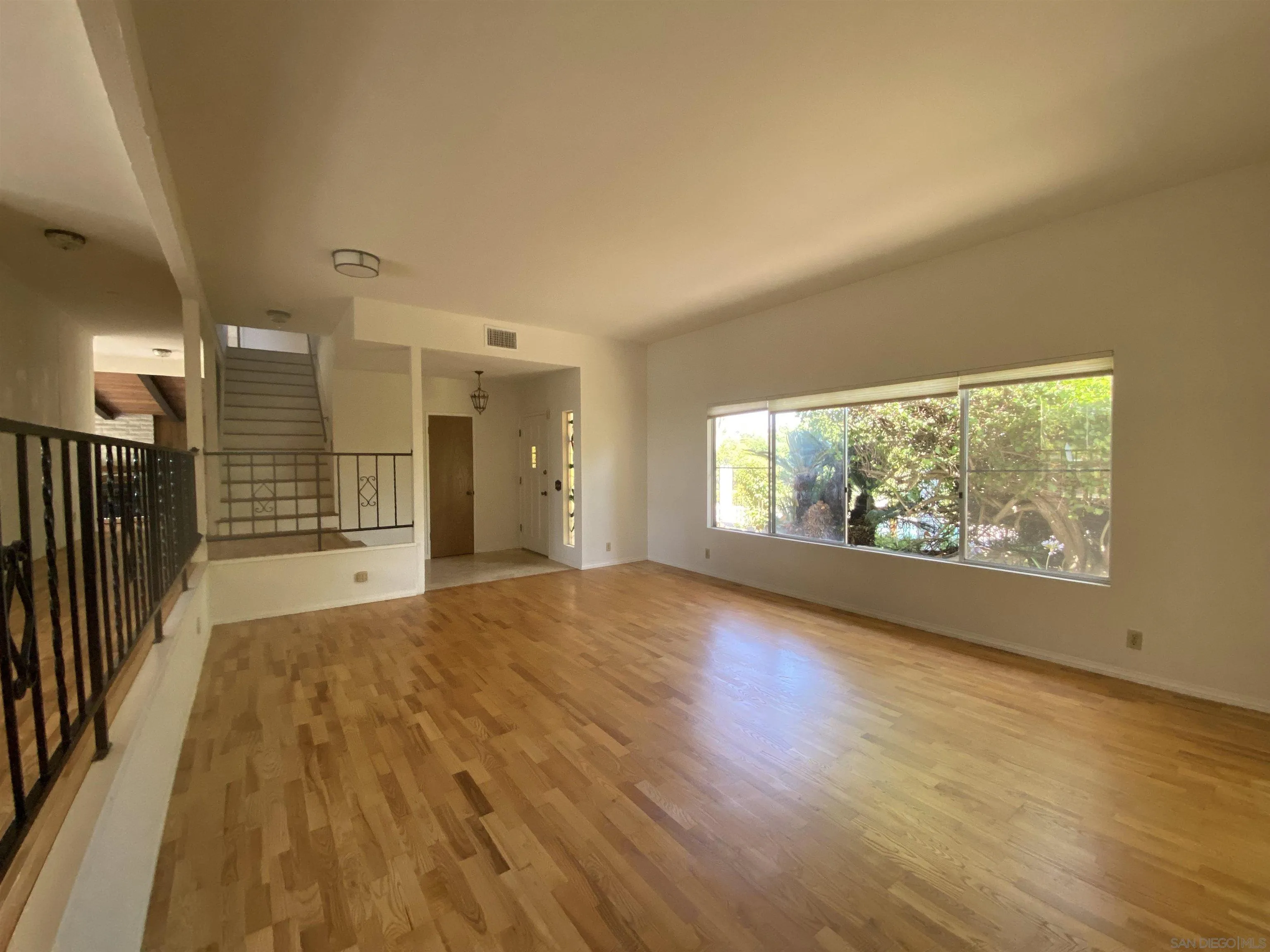 1780 Rabbit Hill Fallbrook, CA 92028 - Photo 16 of 60 an empty room with wooden floor and windows