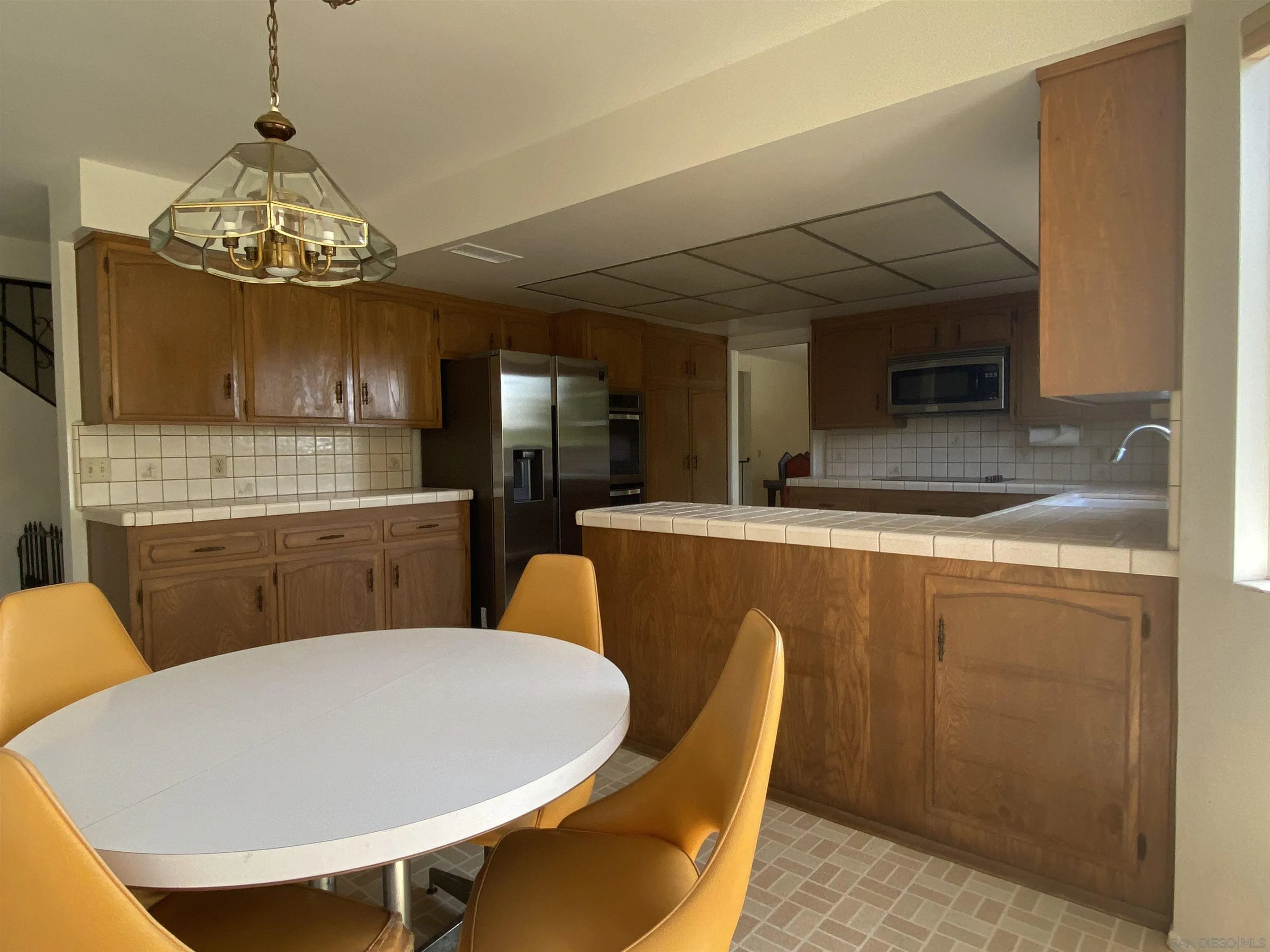 1780 Rabbit Hill Fallbrook, CA 92028 - Photo 26 of 60 a view of a dining room with furniture a chandelier and kitchen view