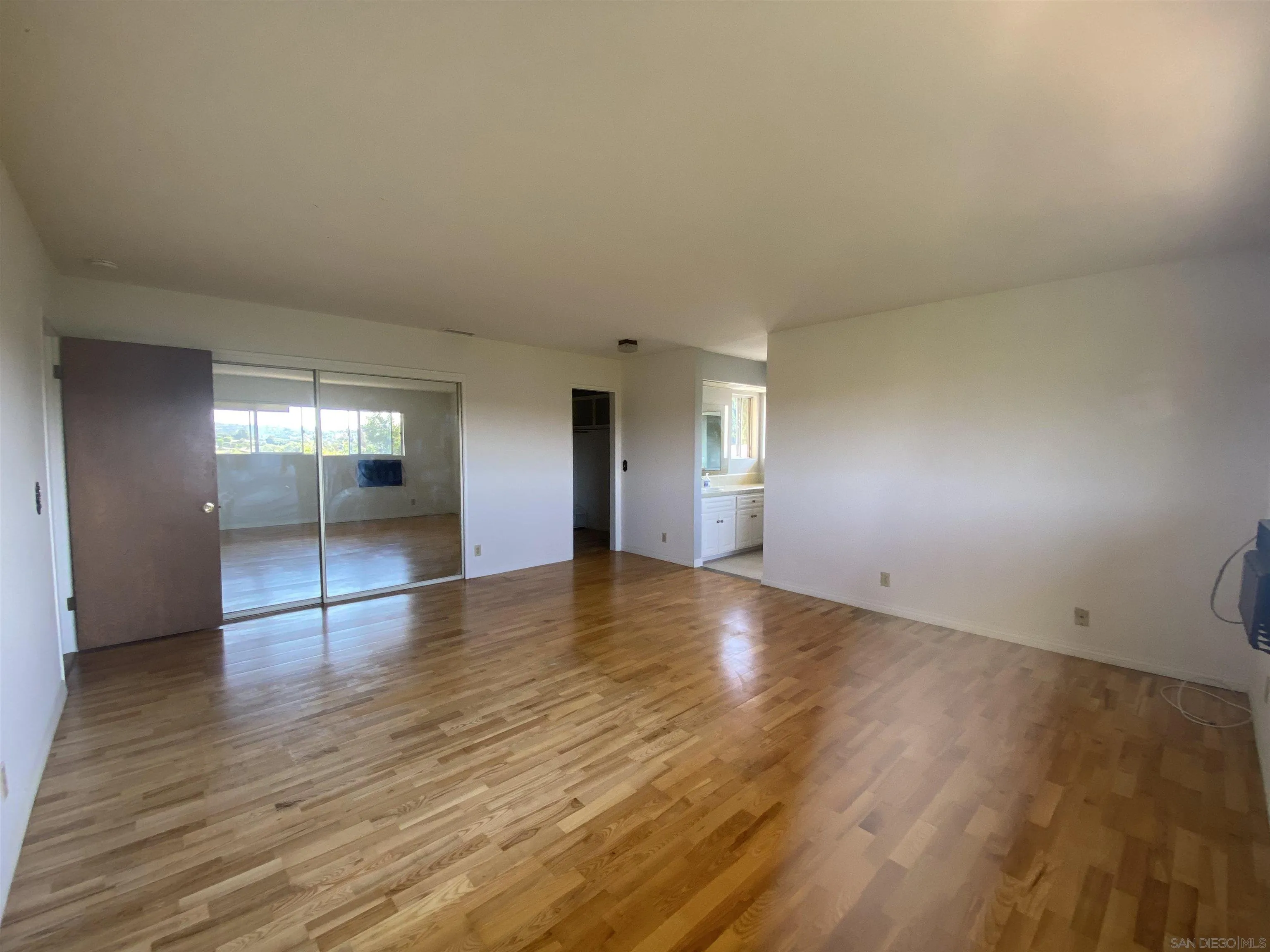 1780 Rabbit Hill Fallbrook, CA 92028 - Photo 35 of 60 an empty room with wooden floor and windows