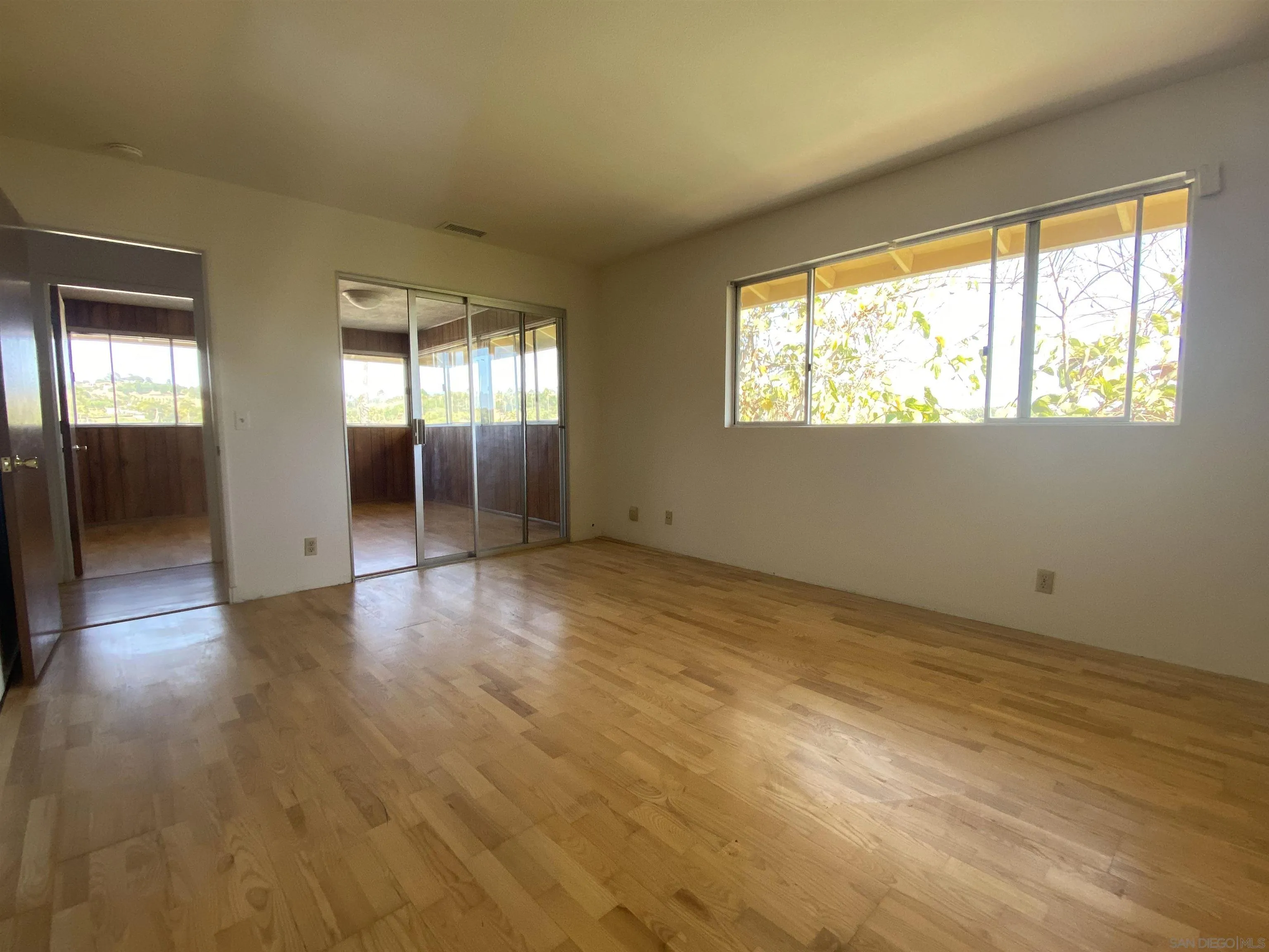 1780 Rabbit Hill Fallbrook, CA 92028 - Photo 42 of 60 an empty room with wooden floor and windows