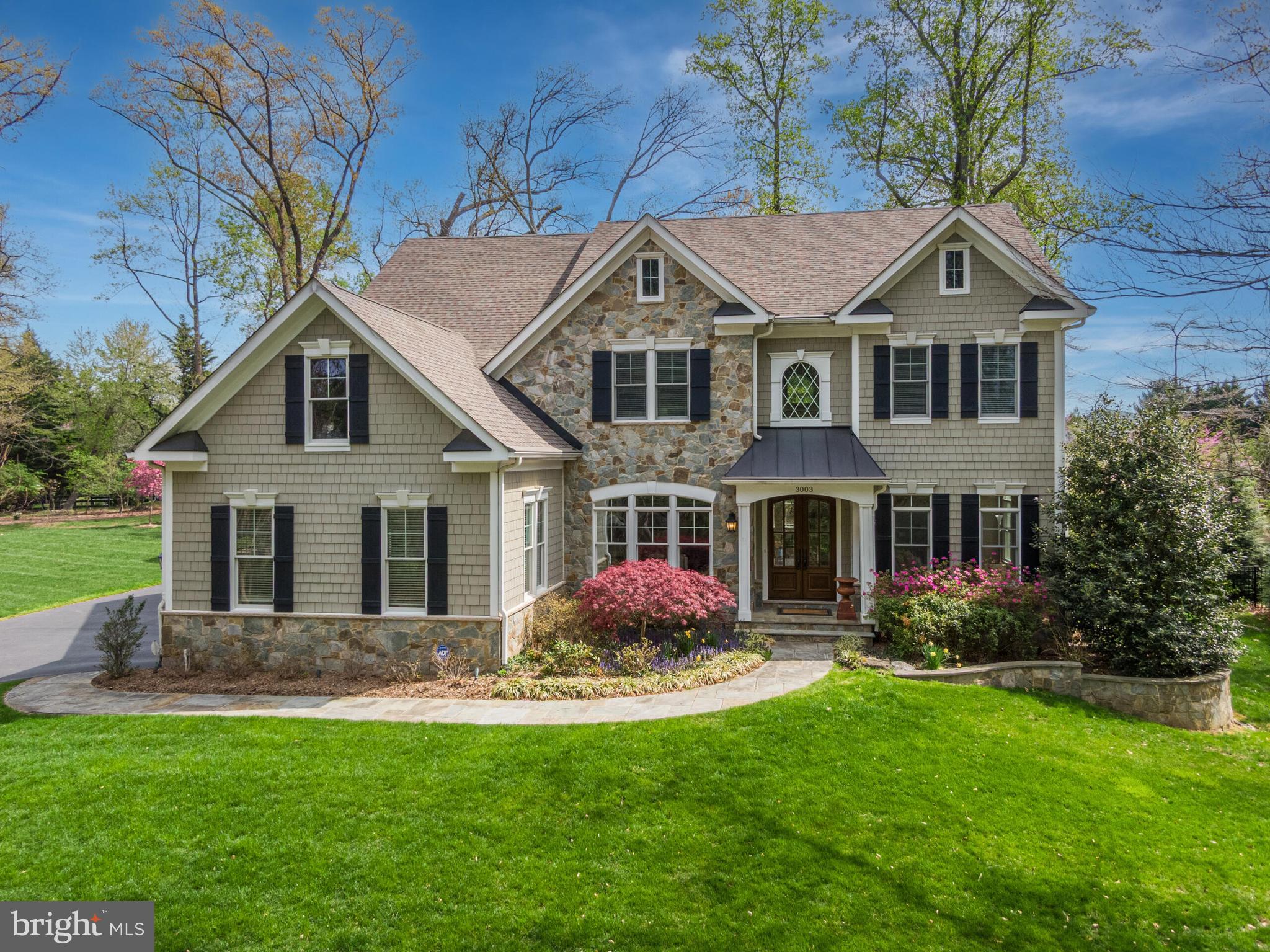 a front view of house with yard and green space